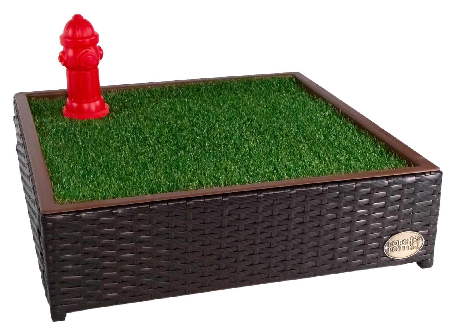A dog potty training pad with synthetic grass and a red fire hydrant, set in a dark brown wicker container.